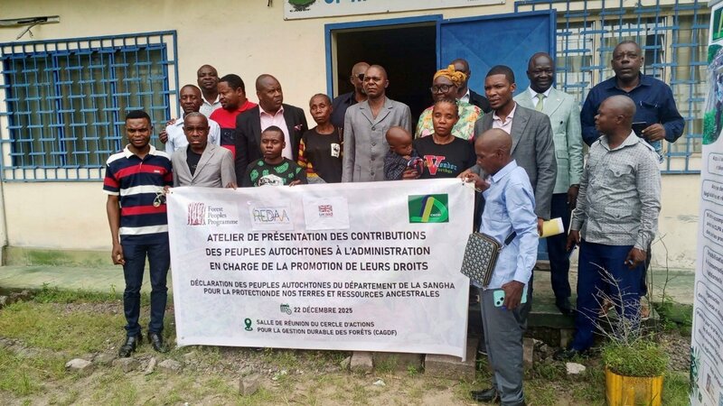 Group of people stood in front of a banner